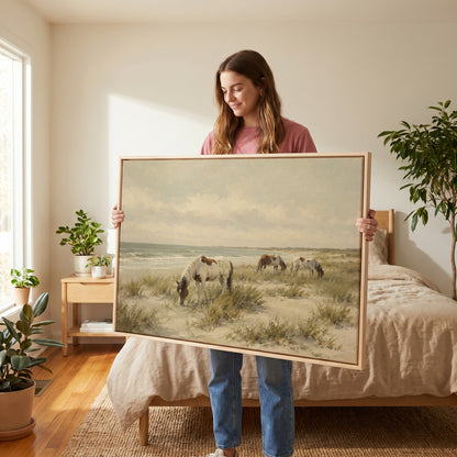 Neutral canvas wall art showing wild ponies grazing on a dune beach beside pale ocean surf