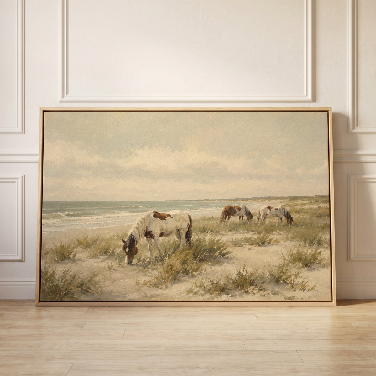 Wild ponies grazing on a dune beach beside pale ocean surf, canvas wall art