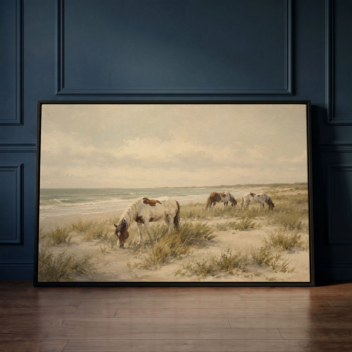 Pale coastal canvas wall art showing wild ponies grazing on a dune beach beside pale ocean surf