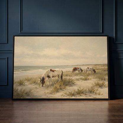 Pale coastal canvas wall art showing wild ponies grazing on a dune beach beside pale ocean surf