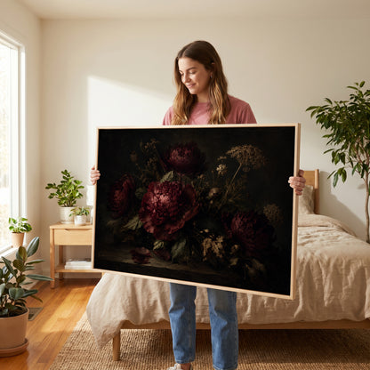 Burgundy canvas wall art showing burgundy peonies and dried seed heads on a dark table