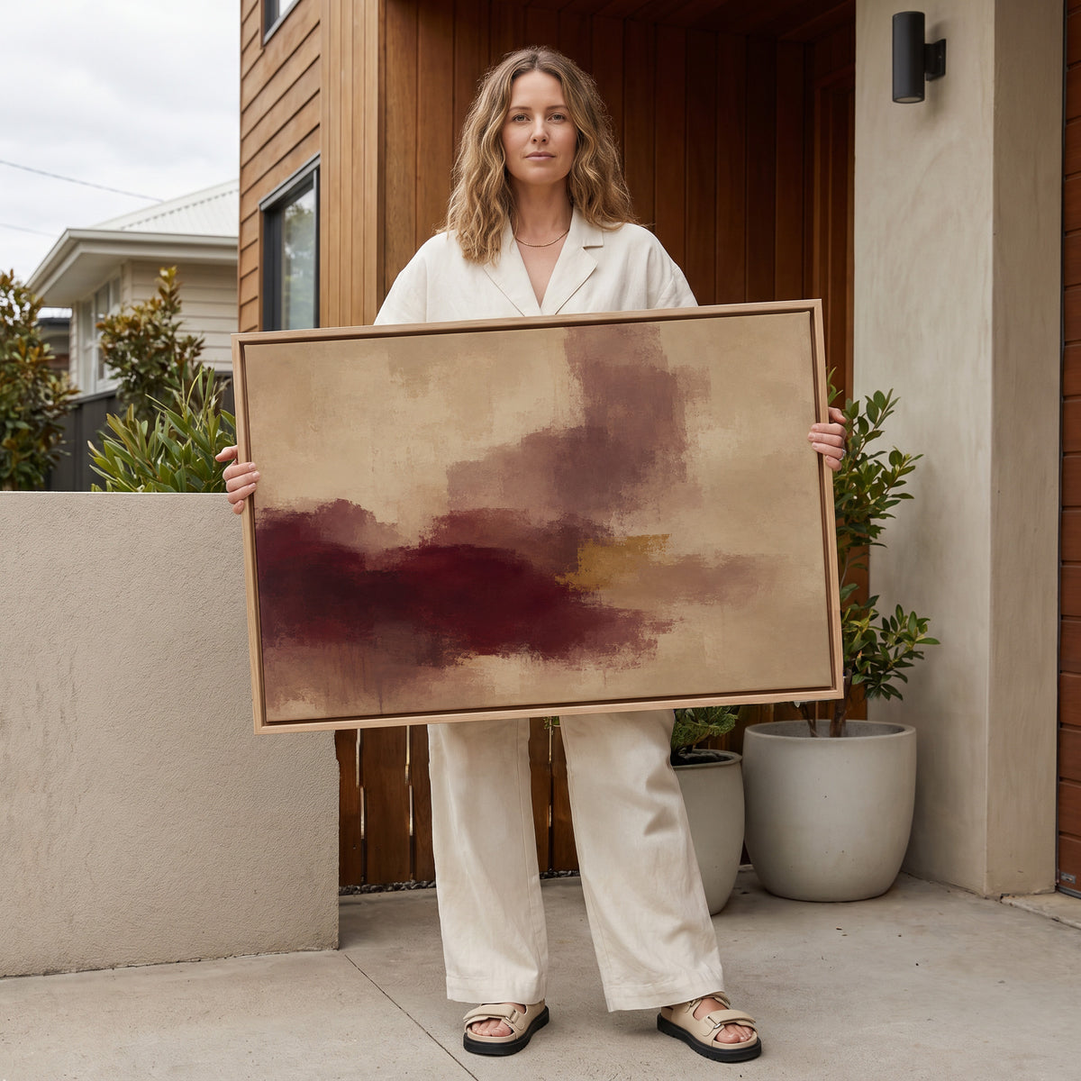 Modern abstract canvas wall art showing abstract painting with a burgundy mass, mauve column and one gold bar on warm beige