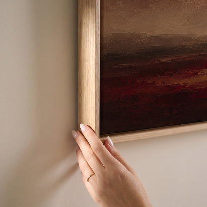 Deep red storm clouds over a wide marsh with a thin band of silver water at the horizon, horizontal canvas print