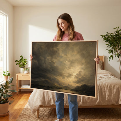Dramatic sky canvas wall art showing broken storm cloud lit from behind over a still lake with low fells and tiny white cottages