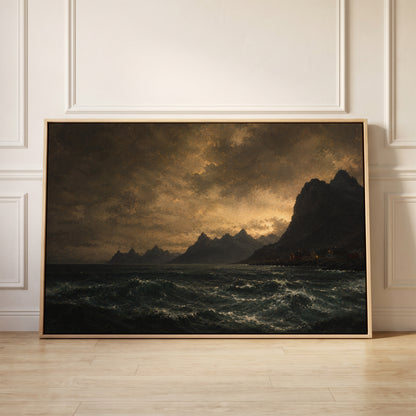 Lit red houses on a rocky Norwegian shore below jagged peaks with a dark sea in the foreground, canvas wall art