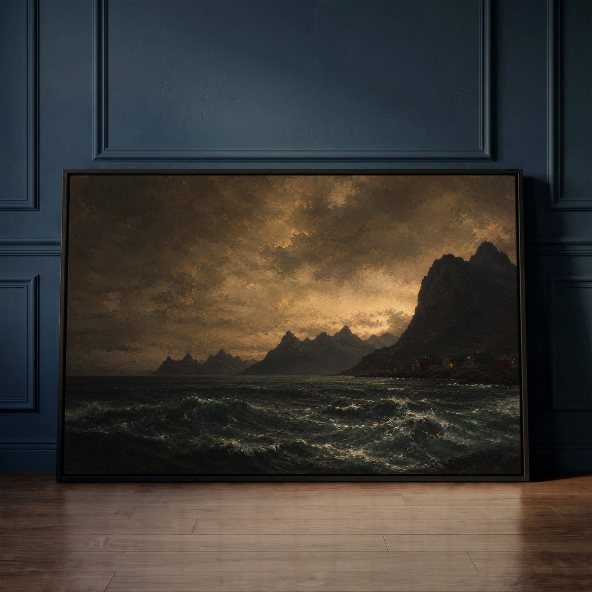 Dark canvas wall art showing lit red houses on a rocky Norwegian shore below jagged peaks with a dark sea in the foreground