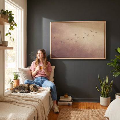 A scattered flock of small dark birds flying across a dusty rose and cream ground, wall art print