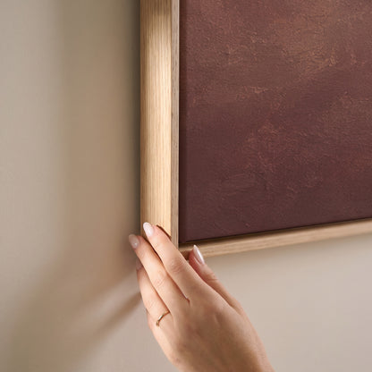A scattered flock of small dark birds flying across a dusty rose and cream ground, horizontal canvas print