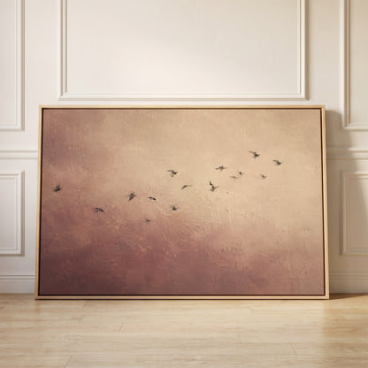 A scattered flock of small dark birds flying across a dusty rose and cream ground, canvas wall art