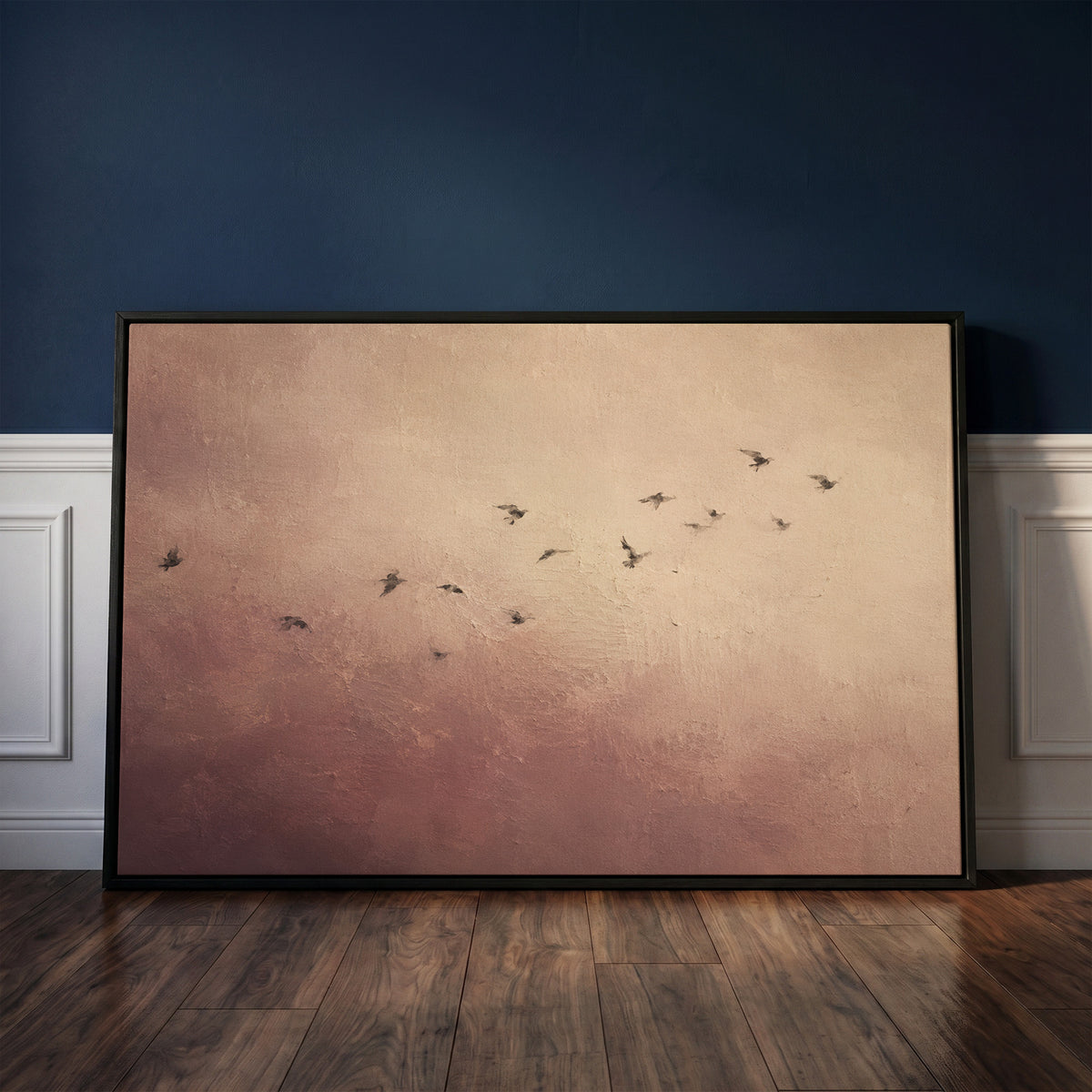Neutral canvas wall art showing a scattered flock of small dark birds flying across a dusty rose and cream ground