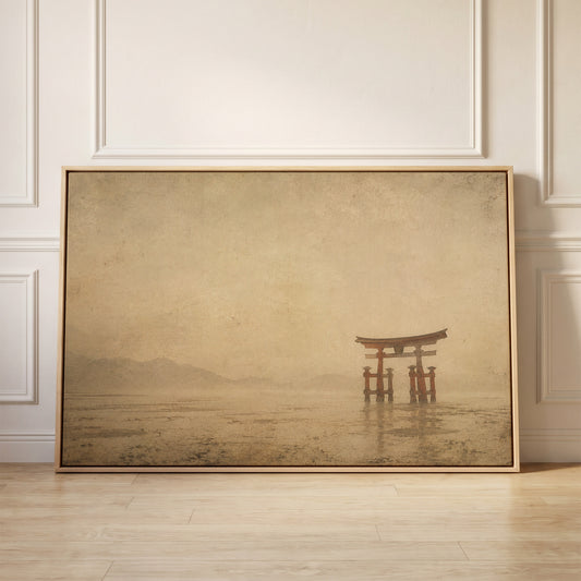 A vermilion torii gate standing in shallow tidal water with misty hills far behind, canvas wall art