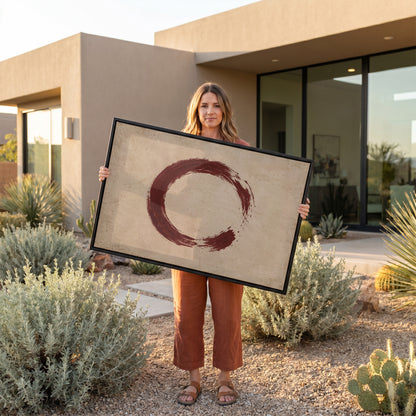 Minimalist canvas wall art showing a single oxblood enso circle with an open gap, brushed on a warm cream ground