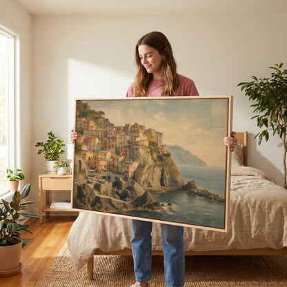 Mediterranean canvas wall art showing pastel houses stacked on a cliff above a small harbour with boats at Manarola, Italy