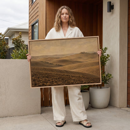 Rolling hills canvas wall art showing rolling ploughed Tuscan clay hills with a farmhouse and cypress trees on a distant ridge