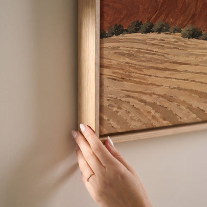 Rolling ploughed clay hills in red and cream with a small farmhouse on a distant ridge, horizontal canvas print