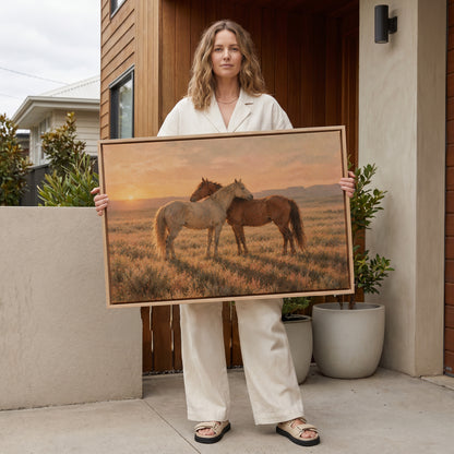 Sunset canvas wall art showing grey and chestnut horse standing close together in golden light on open range
