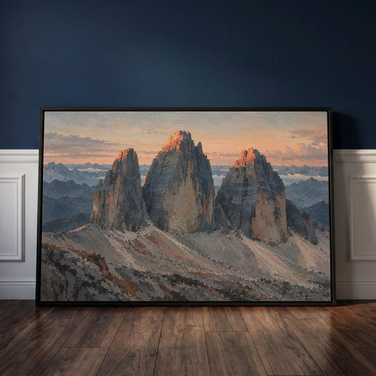 Moody landscape canvas wall art showing three grey rock towers at dawn with warm light on the summits and scree below