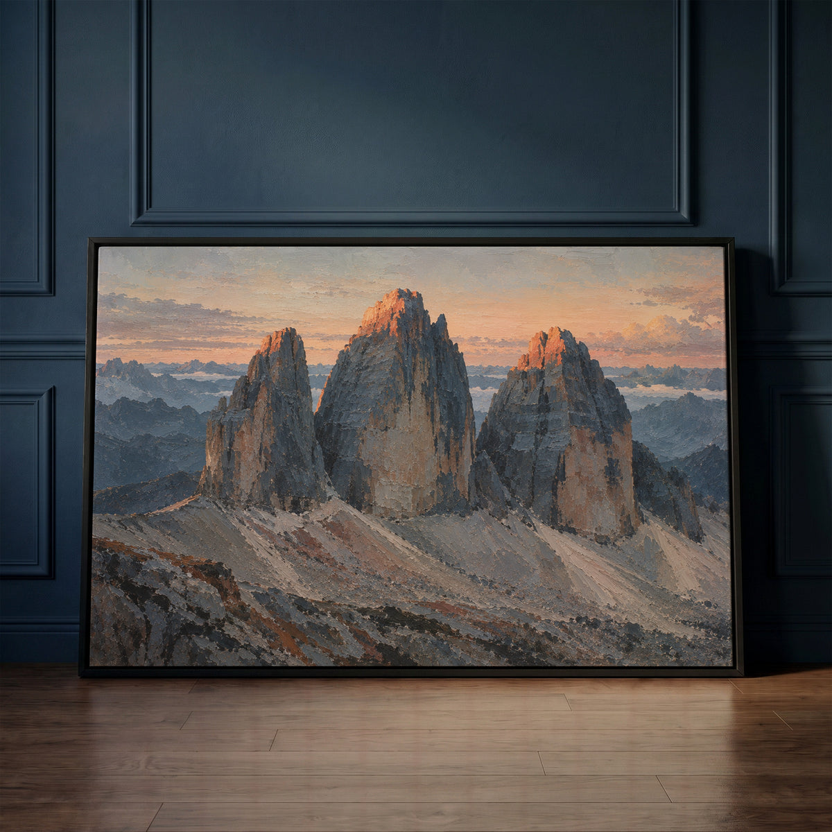 Hiking canvas wall art showing three grey rock towers at dawn with warm light on the summits and scree below