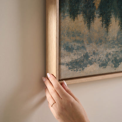 Still lake mirroring a spit of dark pines with snow dusted peaks behind, horizontal canvas print