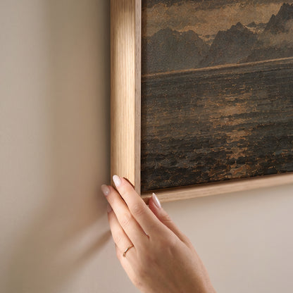 Sharp granite peak rising from dark water with tiny red cabins at its base, horizontal canvas print