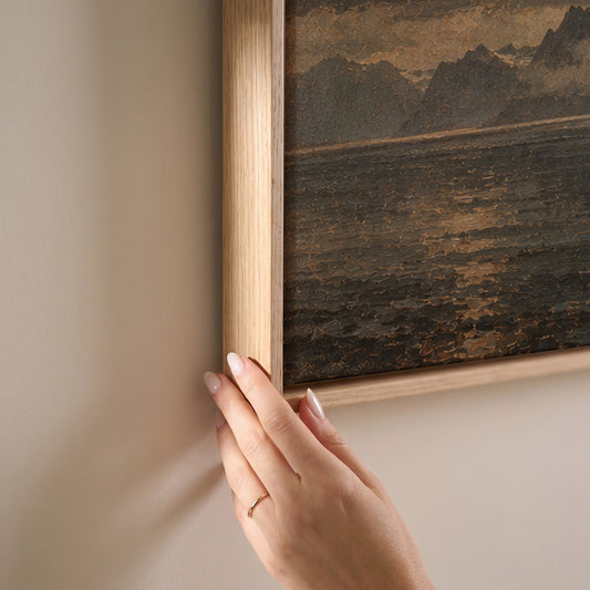 Sharp granite peak rising from dark water with tiny red cabins at its base, horizontal canvas print