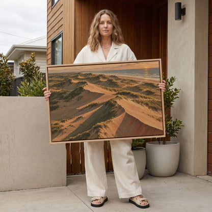 Beach canvas wall art showing aerial view of grass covered sand dunes with long shadows running down to the sea