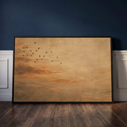 Nature canvas wall art showing small flock of dark birds flying across a warm ochre and rust coloured sky
