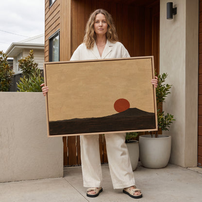 Dusk landscape canvas wall art showing rust red sun disc resting on the shoulder of a dark volcanic cone at dusk