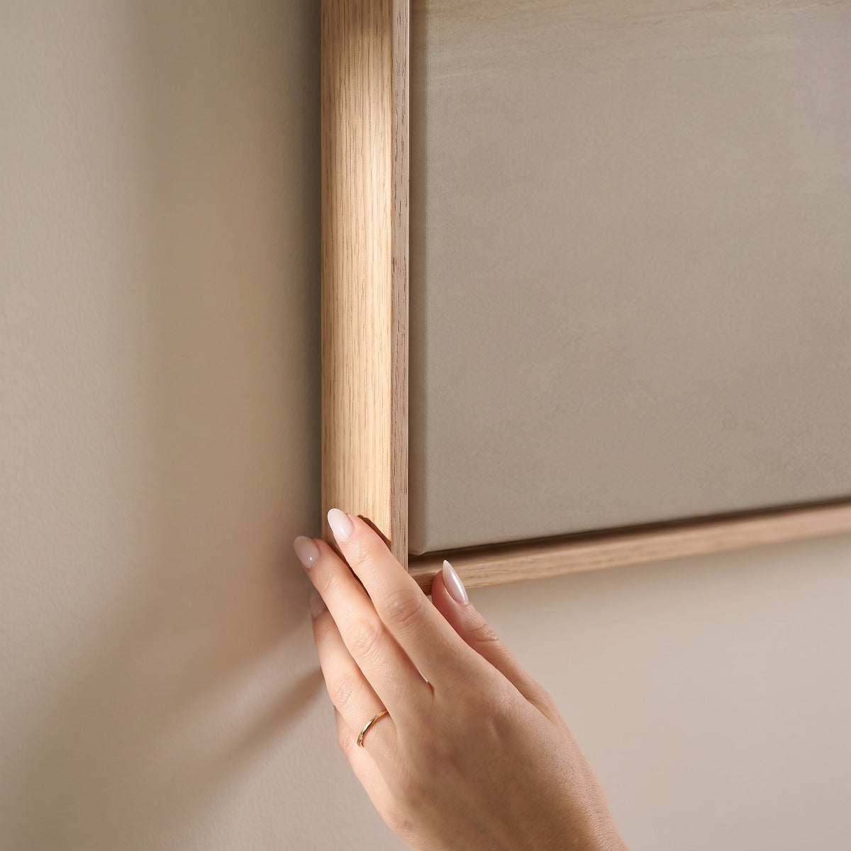 A single soft golden band drawn across a pale ivory ground, horizontal canvas print