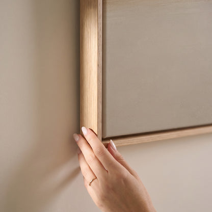 A single soft golden band drawn across a pale ivory ground, horizontal canvas print