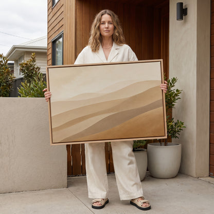 Minimalist landscape canvas wall art showing pale desert ridges layered in tan, greige and ochre under a faint sky