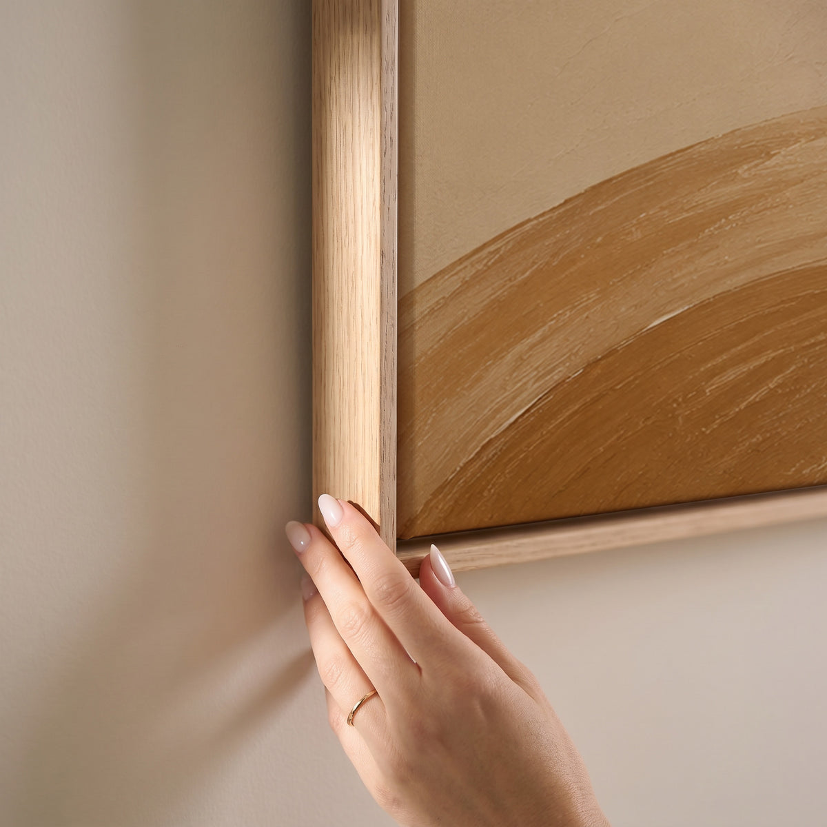 One long caramel and cream brushstroke sweeping across a warm sand ground, horizontal canvas print