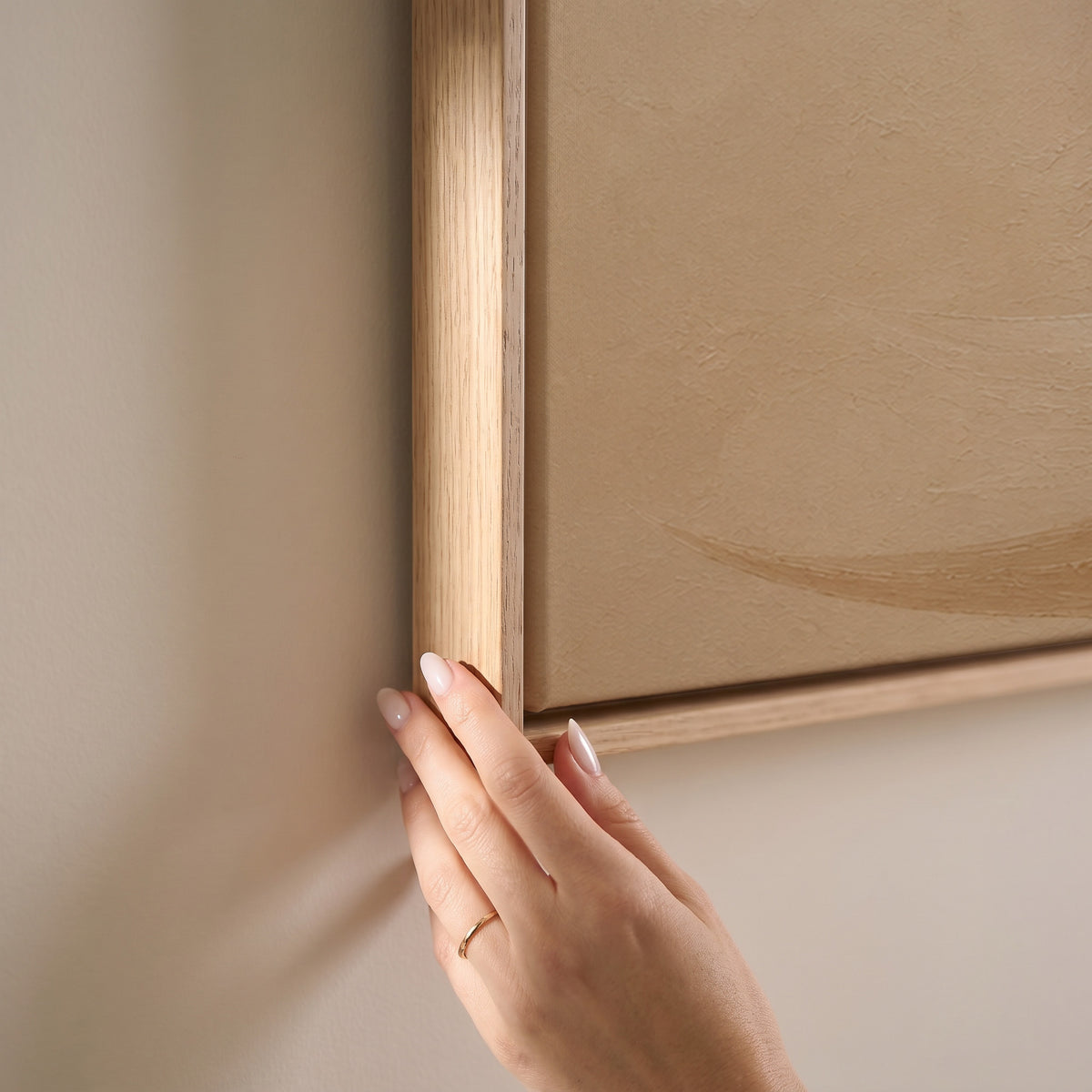 A cream and caramel brushstroke curling into an open loop on a sand ground, horizontal canvas print