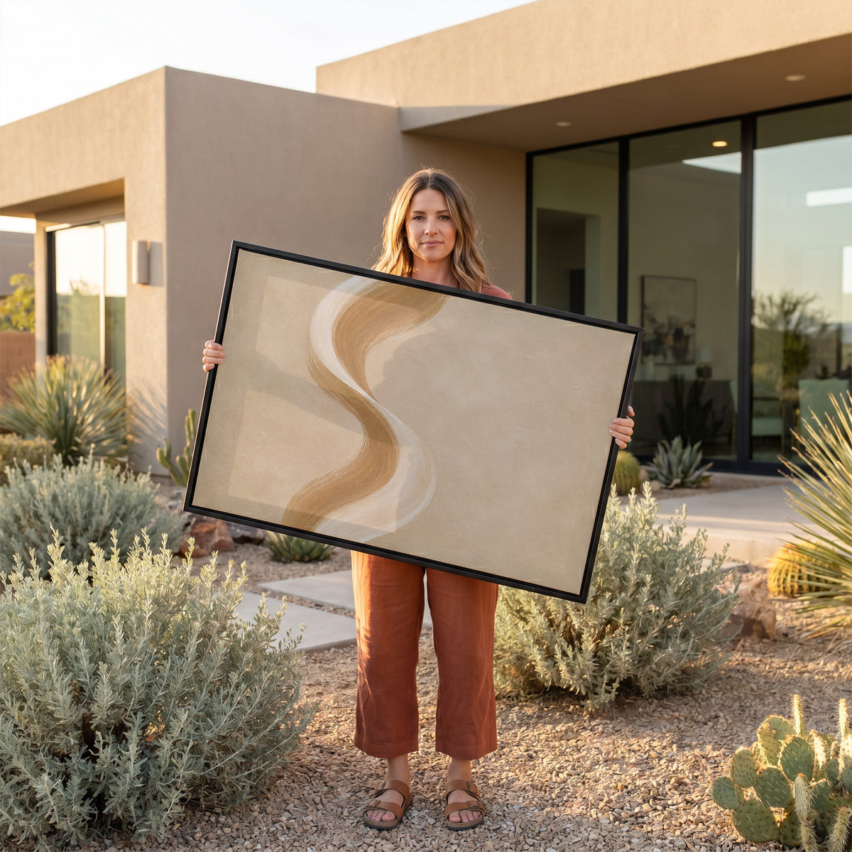 Modern minimal canvas wall art showing a tall S-curved brushstroke in cream and caramel on a warm sand ground