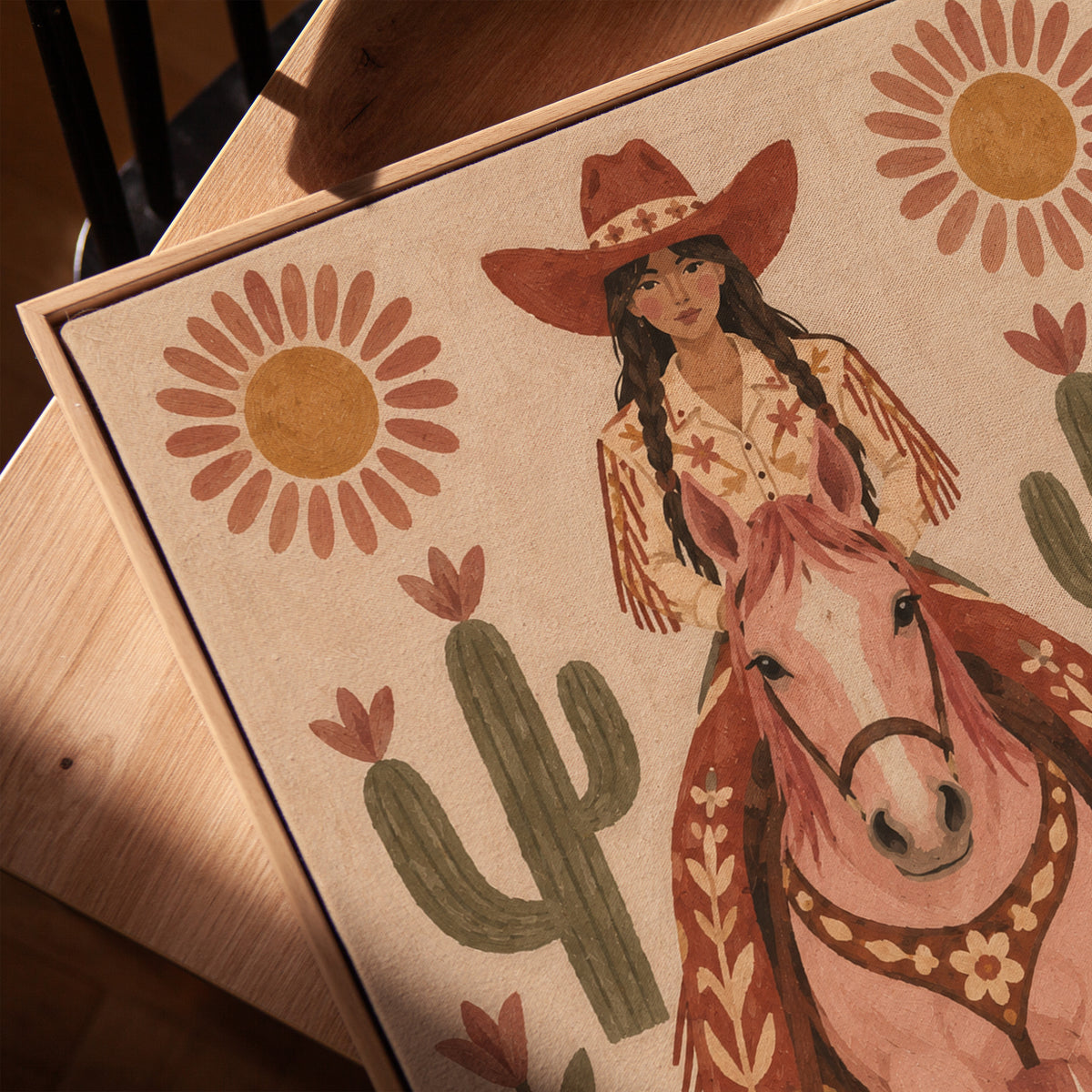 Folk art cowgirl on a pink horse framed by cacti and flowers, vertical canvas print
