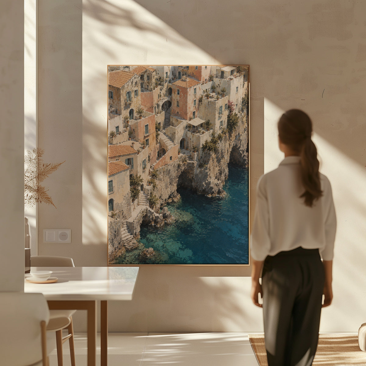 Neutral coastal canvas wall art showing cliffside Mediterranean village seen from above with turquoise sea below