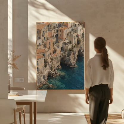 Neutral coastal canvas wall art showing cliffside Mediterranean village seen from above with turquoise sea below