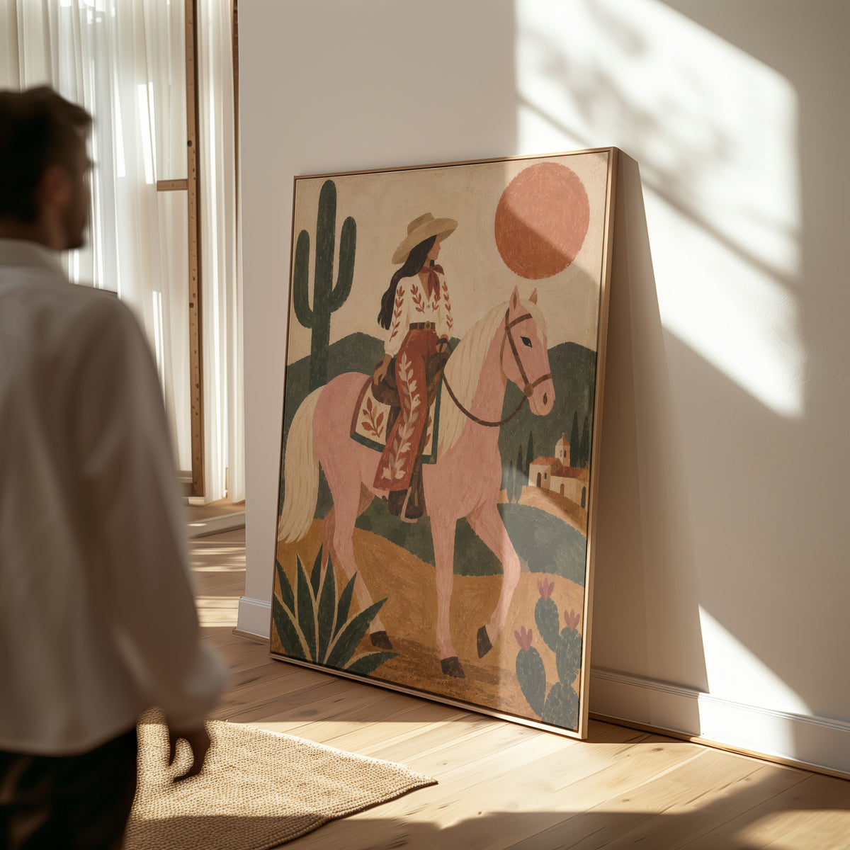 Folk art canvas wall art showing cowgirl riding a pale rose horse past cacti under a red desert sun
