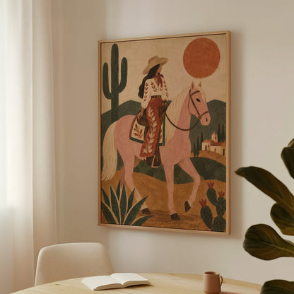 Western canvas wall art showing cowgirl riding a pale rose horse past cacti under a red desert sun