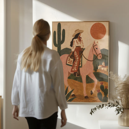Pink horse canvas wall art showing cowgirl riding a pale rose horse past cacti under a red desert sun