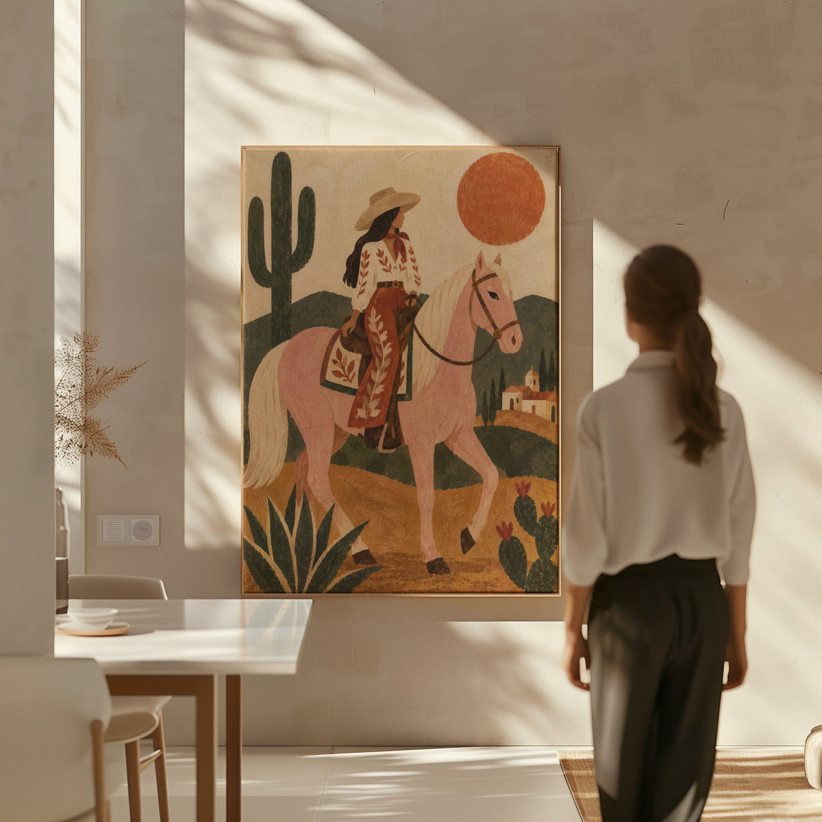 Cowgirl riding a pale rose horse past cacti under a red desert sun, canvas print