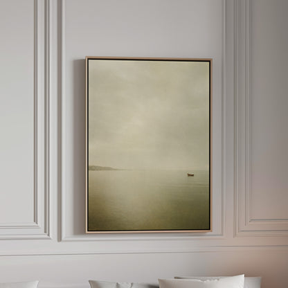 A single small boat on flat pale water with a distant headland in mist, canvas wall art