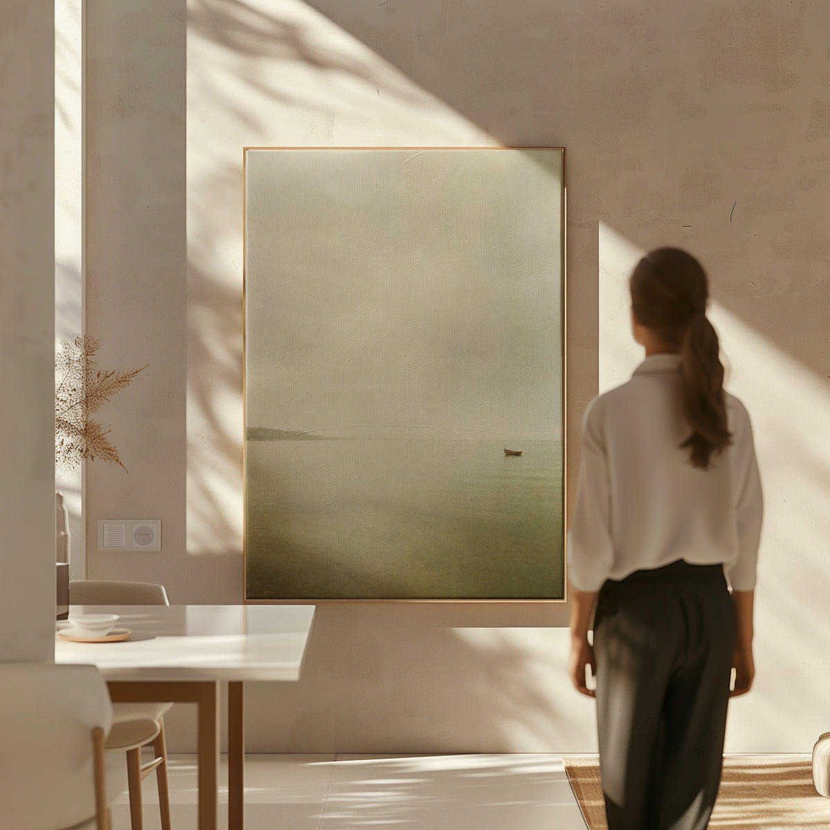 Beige canvas wall art showing a single small boat on flat pale water with a distant headland in mist