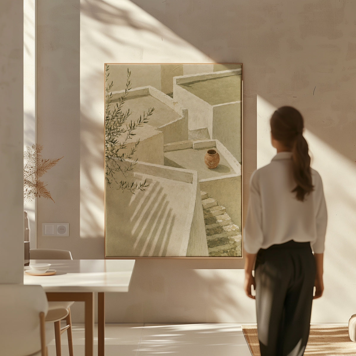 Neutral canvas wall art showing lime-washed terraces and steps in sunlight with a terracotta jar and olive branch