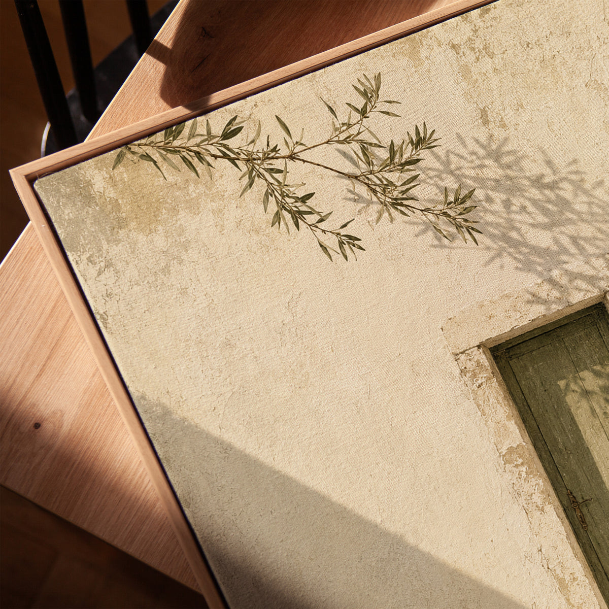 Weathered green door in a bone limestone wall with olive branch shadows, vertical canvas print