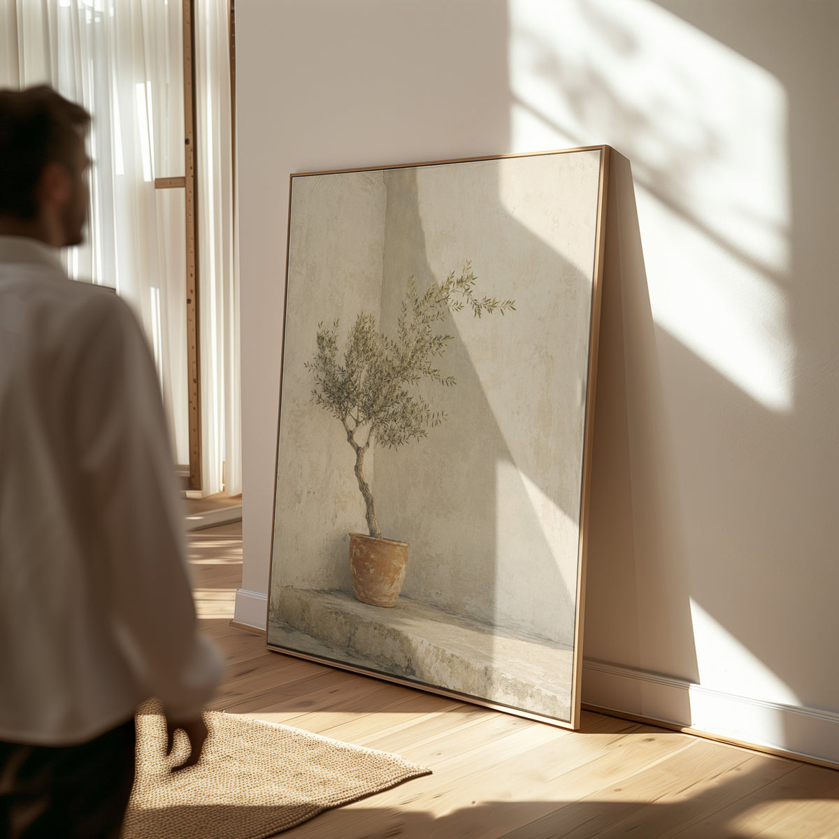 Beige canvas wall art showing small olive tree in a terracotta pot in a sunlit courtyard corner