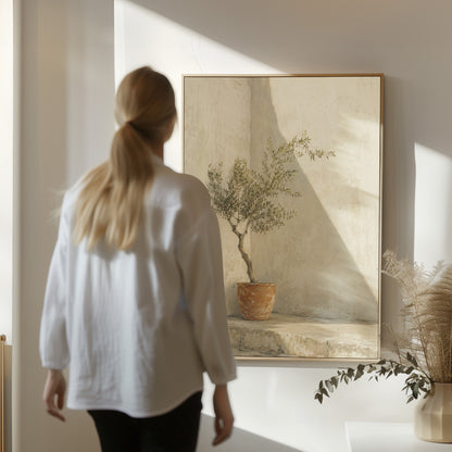 Calm canvas wall art showing small olive tree in a terracotta pot in a sunlit courtyard corner