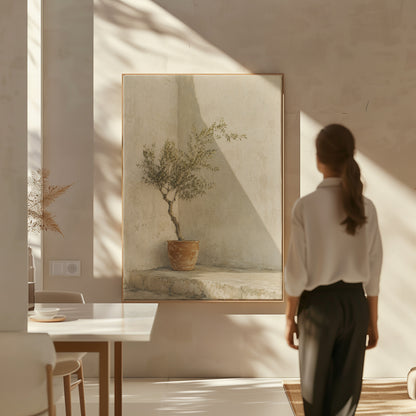 Terracotta canvas wall art showing small olive tree in a terracotta pot in a sunlit courtyard corner