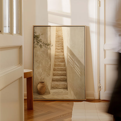 Neutral canvas wall art showing narrow stone stairway between sunlit walls with a terracotta urn below