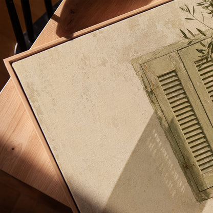Sage green louvred shutters on a bone wall with an olive branch above, vertical canvas print